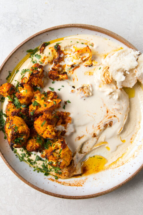 Roasted Harissa Cauliflower on Hummus with Tahini Sauce