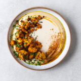 Roasted Harissa Cauliflower on Hummus with Tahini Sauce