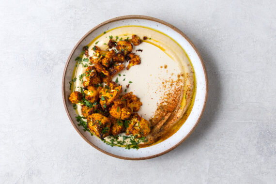 Roasted Harissa Cauliflower on Hummus with Tahini Sauce