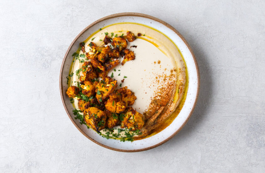 Roasted Harissa Cauliflower on Hummus with Tahini Sauce