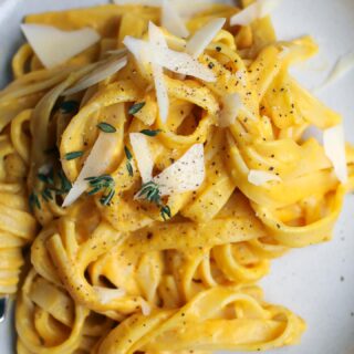 Pumpkin Alfredo Fettuccine recipe! Yet another pumpkin pasta dish to add to your line up. This one was a recipe I wrote for @foodnetworkca in 2015 so you know it’s one of the OGs. 

1 lb fettuccine
1 tbsp olive oil
2 tbsp unsalted butter
2 cloves garlic, chopped finely
1 tbsp flour
15 oz can pumpkin puree
1 cup heavy cream
kosher salt
fresh ground black pepper
1 tsp fresh thyme
1 cup grated parmesan cheese

-Heat olive oil & butter over med heat in a large skillet with tall sides or dutch oven.
-Add garlic and cook for 30 seconds until fragrant.
-Add flour and cook 2-3 minutes until begins to brown & smell nutty.
-Turn down the heat to med-low & add pumpkin puree, heavy cream, salt, pepper, thyme, & parmesan.
-Cover & simmer until thickened, about 5 minutes.
- Meanwhile, cook fettuccine in heavily salted water 2 minutes shy of package time for al-dente.
-Reserve 1 1/2 cups of pasta water and drain.
-Add fettuccine to the sauce and toss thinning out with pasta water to get the right consistency.
-Serve immediately!

#pasta #alfredo #pumpkin #pumpkinpasta #fettuccine #fallrecipes